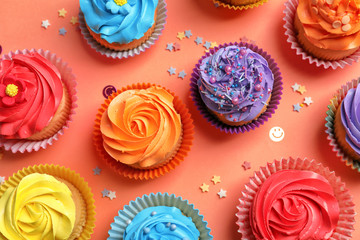 Wall Mural - Tasty cupcakes on color background