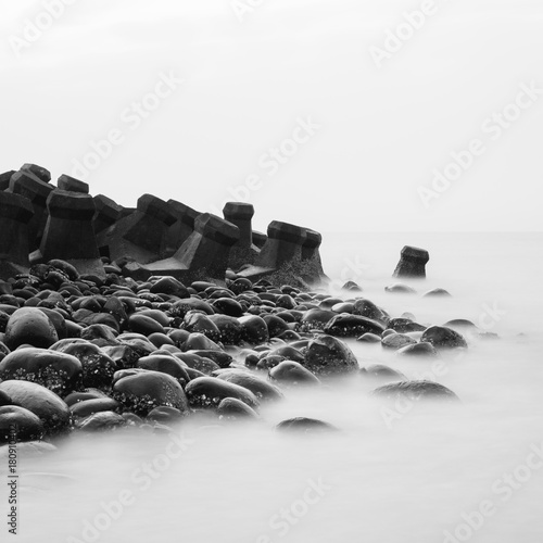 Crashing waves in square black and white.Long exposure. Poster