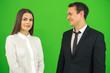 © realstock1 - The happy businessman and businesswoman stand on the green background