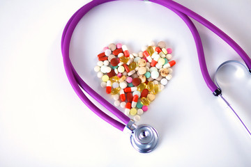 Canvas Print - Stethoscope and some pills - isolated on a white background