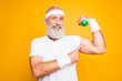 © deagreez - Check this out! Cheerful excited modern cool pensioner grandpa practising bodybuilding, exercising holding equipment up, lifts it with strength and power. Body care, hobby, weight loss lifestyle