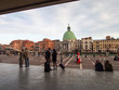 Tourists outside a train station overlooking buildings and an open square in Venice, Italy