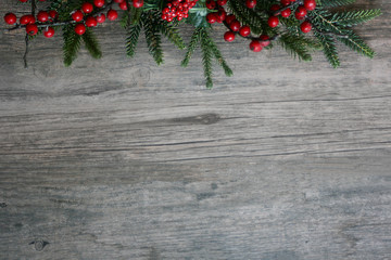 Wall Mural - Christmas Pine Tree Branches and Berries Over Rustic Wood Horizontal Background