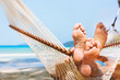 © Song_about_summer - family relaxing on the beach in hammock, exotic holidays travel, closeup of feet