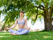 © Sergey Nivens - Young woman practicing yoga in the park