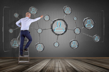 Poster - Businessman in front of a wall with network connection with people linked each other in technology wheel - 3d rendering