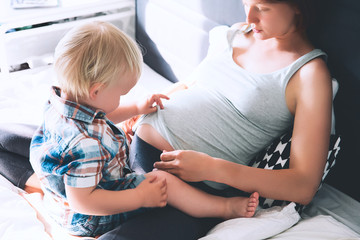 pregnant mother and son at home.
