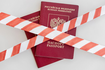 Wall Mural - White and red warning tape over the two Russian passports