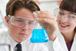 © highwaystarz - Male Pupil And Teacher Conducting Chemistry Experiment