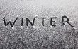 Winter coming text on the snowy car window
