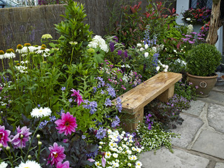 Wall Mural - Garden seating in a colorful flower garden