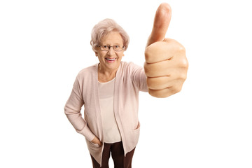 Sticker - Elderly woman making a thumb up sign and smiling