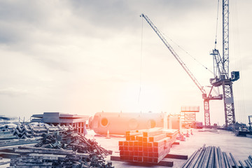 Abstract Industrial background with construction cranes and sunlight