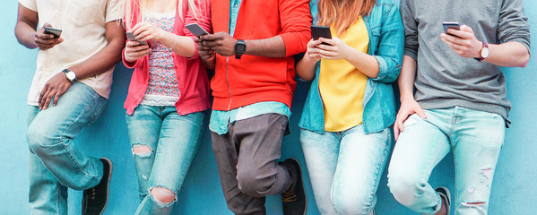 Group of young friends watching smart mobile phones