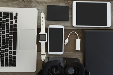 Various electronic gadgets on wooden surface