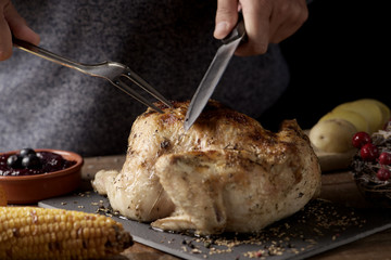 Canvas Print - young man carving a roast turkey