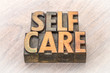 self-care word abstract in wood type
