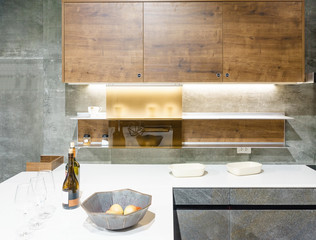Sticker - Modern kitchen furniture with contemporary kitchenware like hood, black induction stove and oven in house.