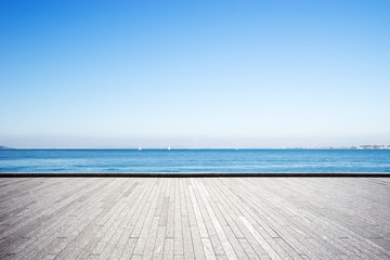 Wall Mural - empty marble floor with blue sea in blue sky