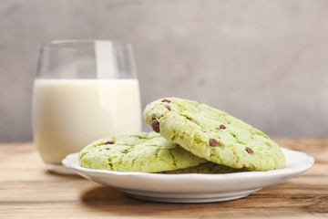 Sticker - Plate with fresh mint chocolate chip cookies and glass of milk on table