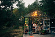 © Maskot - People having party in greenhouse