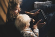 © Maskot - Father and baby daughter looking at digital tablet
