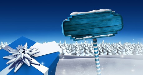 Poster - GIft and Wooden signpost in Christmas Winter landscape