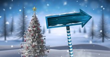 Wooden Signpost In Christmas Winter Landscape With Christmas