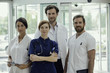 © PhotoAlto - Portrait of doctors standing in clinic