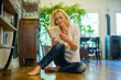 © PhotoAlto - Mature woman relaxing on floor with book at home
