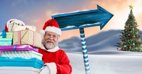 Poster - Santa holding gifts and Wooden signpost in Christmas Winter