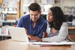 © Monkey Business - Two Mature Students Working On Laptop In College Library Together