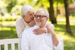 © Syda Productions - happy senior couple sitting on bench at park
