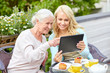 © Syda Productions - daughter with tablet pc and senior mother at cafe