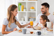 © Syda Productions - happy family having breakfast at home