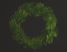 Christmas Decorative Wreath  With Ornament  On Black Background. Made From Thuja, Flower, Pine Cones. Floral Design. Festive Mod.