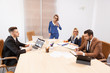 © DC Studio - Team of business people at meeting in the conference room. Two successful business women and two businessmen at the desk. They are discussing new projects