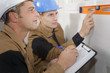 © auremar - constructor showing assistant measuring the wall indoors