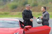 race engineer talking with pilot about strategy near lamborghini
