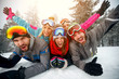 Group of friends on winter holidays - Skiers lying on snow and having fun