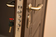 Closeup shot of modern door lock with a key. Empty space