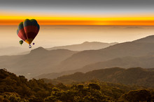 Beautiful Landscape Of Foggy Morning In The Mountains With  Hot-air Balloons Flying Over The Mountain.