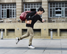 Asian Guy Running In A Hurry Watching Time