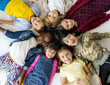 © Rawpixel.com - A group of primary schoolers lying on the ground and smiling