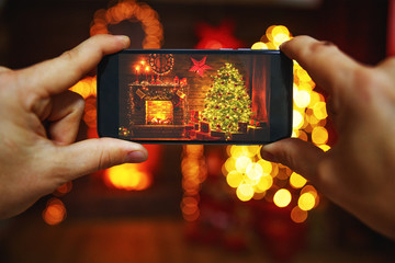 Wall Mural - photo christmas interior with a christmas tree and fireplace made on smartphone
