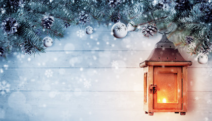 Christmas background with spruce branches and wooden lantern.