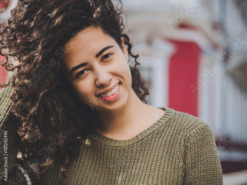 Portrait Of Happy Young Hispanic Woman With Beautiful Curly Hair