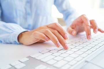 female woman office worker typing on the keyboard