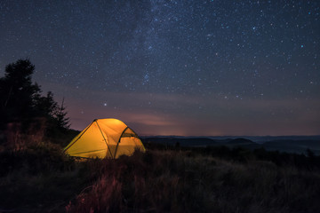 iluminated tent under stars
