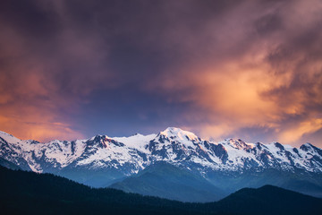 Canvas Print - Beautiful colorful sunset over the snowy mountain peak. Nature landscape. Dramatic overcast pink sky. Holiday, travel, sport, recreation. Main Caucasian ridge, Svaneti, Georgia. Retro toning filter